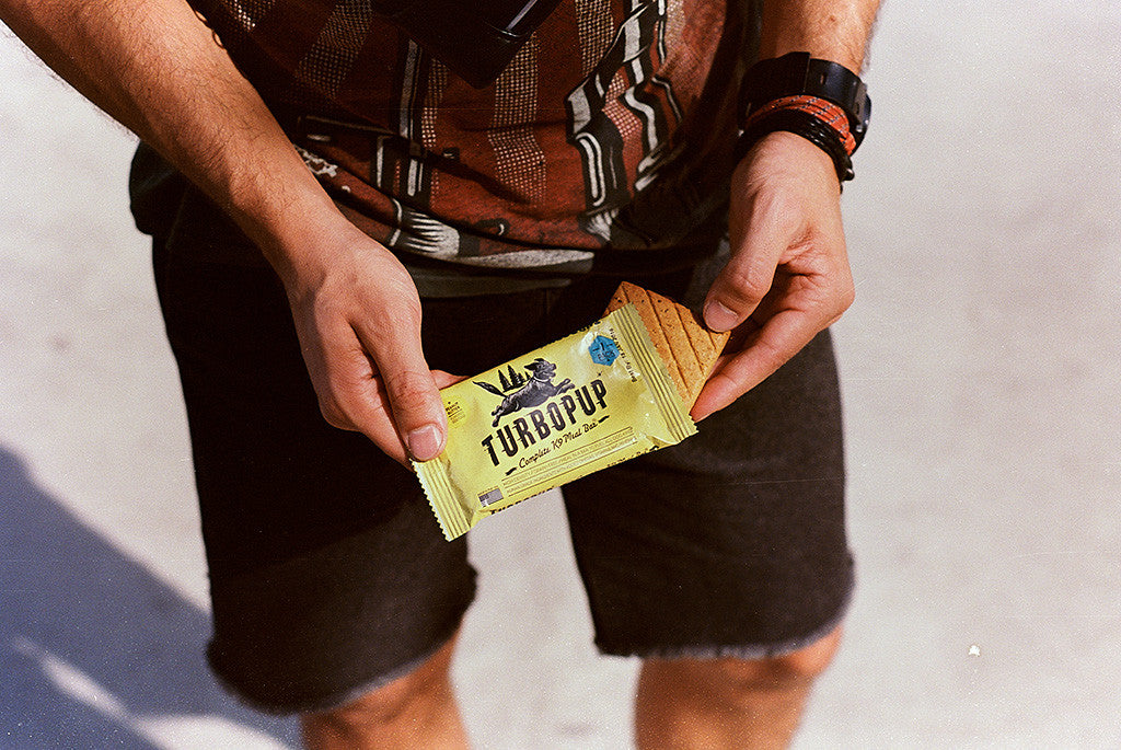 Man holding a Turbopup in Peanut Butter Flavor - Dog Power Bar | Zee.Dog